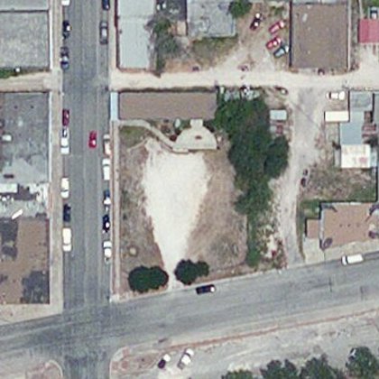 Satellite view, December 2010 — the lot is a bare white caliche patch