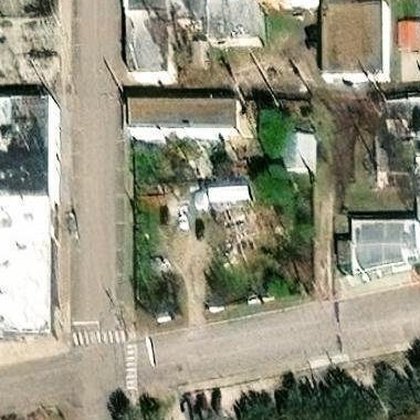 Satellite view, February 2023 — winter, dense growth on the lot
